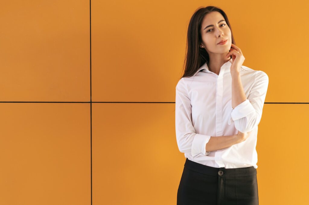 Young woman portrait on yellow background